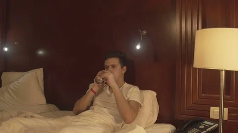 Handsome young man drinking juice at home Stock Footage 73984312