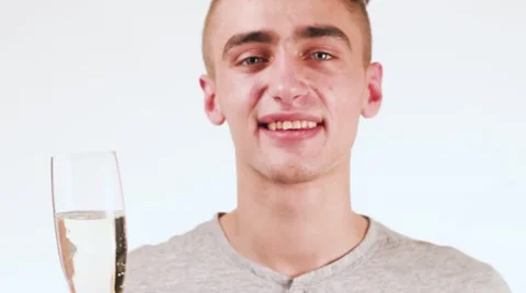 Handsome young man drinking wine looking at the camera. Cute man standing on a 動画素材 58627524