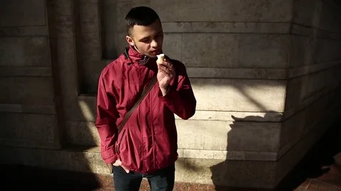 Handsome, Young Man Eating Ice Cream In City Stock Footage