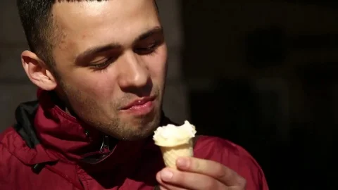 Handsome, Young Man Eating Ice Cream In City Stock Footage 74391341