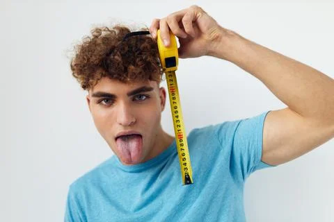 Handsome young man emotions grimace measuring tape Lifestyle unaltered Stock Photos