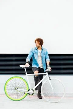 Handsome young man with fixed gear bicycle. Stock Photos