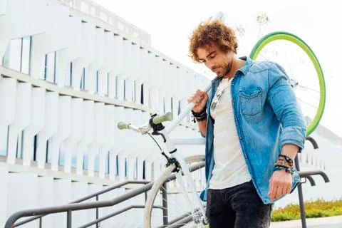 Handsome young man with fixed gear bicycle. Stock Photos