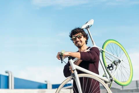Handsome young man with fixed gear bicycle. Stock Photos