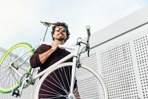Handsome young man with fixed gear bicycle. Stock Photos