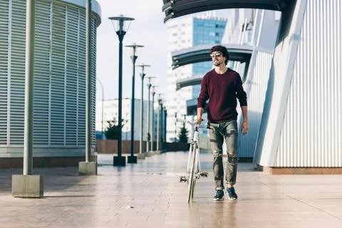 Handsome young man with fixed gear bicycle. Stock Photos