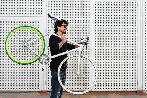 Handsome young man with fixed gear bicycle. Stock Photos