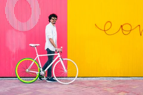 Handsome young man with fixed gear bicycle. Stock Photos
