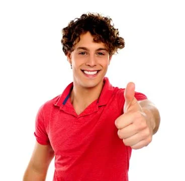 Handsome young man gesturing thumbs-up Stock Photos