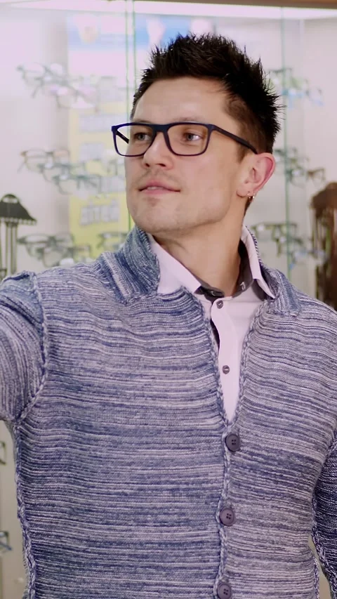 Handsome young man in glasses, spectacles makes selfie at optical store, optics, Stock Footage 318724740