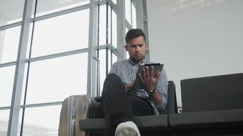 Handsome Young Man Holding Tablet PC And Working at The Airport, Technology Stock Photos