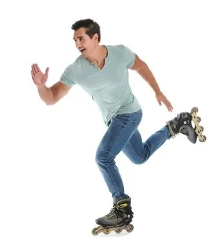 Handsome young man with inline roller skates on white background Stock Photos