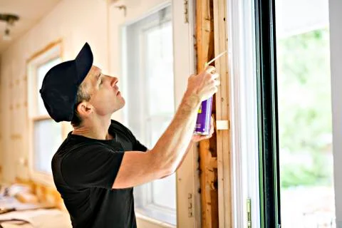 A handsome young man installing Double Sliding Patio Door in a new house Foto stock
