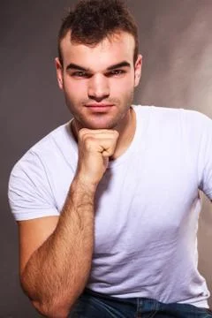 Handsome young man with an intense expression Stock Photos