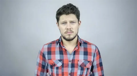 Handsome young man isolated over grey background. Funny face. Stockbeeldmateriaal 41795383