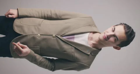 Handsome young man in a jacket isolated over grey wall background showing call Stock-Footage 148052616