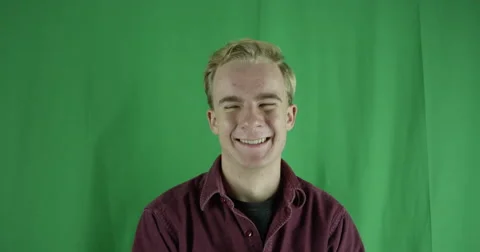 Handsome young man laughs really hard on a greenscreen Vidéo 59724750