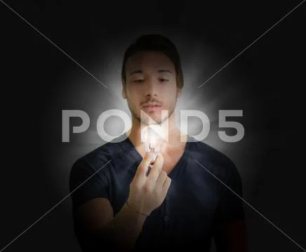 Handsome young man with lightbulb Stock Photos