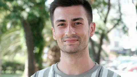 Handsome young man looking at camera 스톡 동영상 137259828