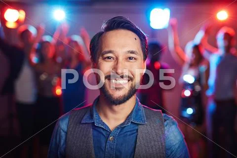 Handsome young man looking at camera with his friends on background Stock Photos