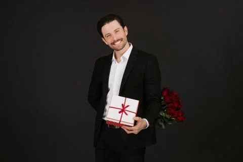 Handsome young man looking at camera and smiling. Happy Valentine`s day. Stock Photos