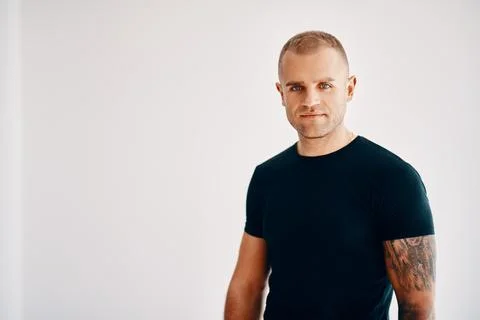 Handsome young man looking to camera over soft white background Stock Photos