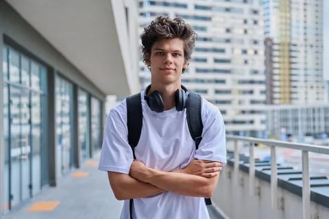 Handsome young man looking at camera outdoors, modern skyscrapers urban style Stock Photos