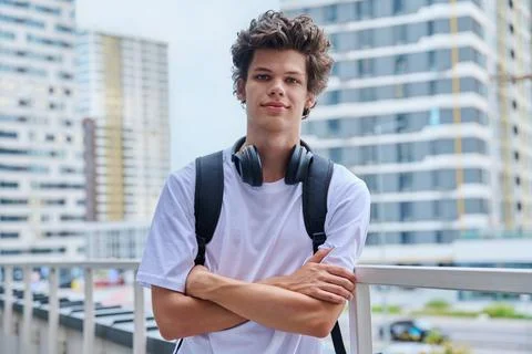 Handsome young man looking at camera outdoors, modern skyscrapers urban style Stock Photos