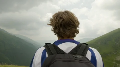 Handsome young man looking over the mountains. Mountaineer Paragliding Adventure Stock-Footage 101279255