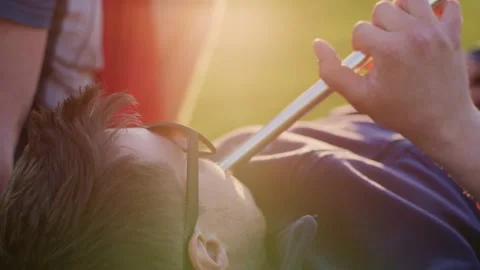 A handsome young man lying in sunglasses smokes a hookah. Close-up. Side view Stock Footage 197851236