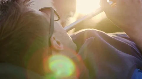 A handsome young man lying in sunglasses smokes a hookah. Close-up. Side view Stock Footage 198513179