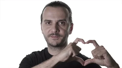 Handsome young man is making heart with his hand. Love sign with gestures, ro Stock Footage 135975433