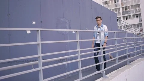 Handsome young man model goes in the direction of the camera Stock Footage 72835637