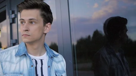 Handsome young man model posing near the window Stock Footage 72835764