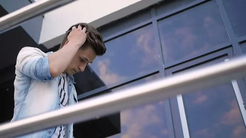 Handsome young man model posing near the window Stock Footage 72835859