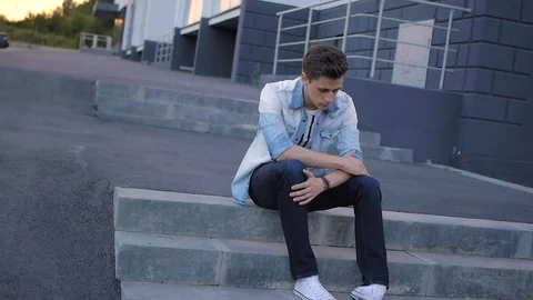 Handsome young man model posing on the steps Stock Footage 72836176