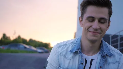 Handsome young man model posing on the steps Video stock 72836302