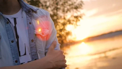 Handsome young man model posing on the lake at sunset Video stock 72838679