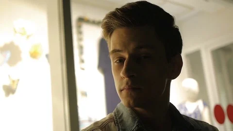 Handsome young man model posing at night in storefront Video stock 72839785