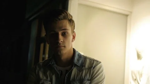 Handsome young man model posing at night in storefront Video stock 72839833