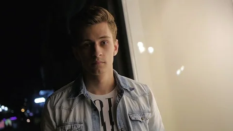 Handsome young man model posing at night in storefront Video stock 72839896