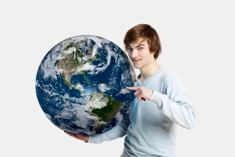 Handsome young man pointing and holding the planet earth on its hands,  isola Stock Photos
