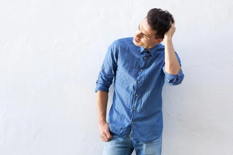 Handsome young man posing with hand in hair Stock Photos