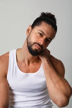 Handsome young man posing in the studio. Mind set and mental health. Vertical. Stockfoto's