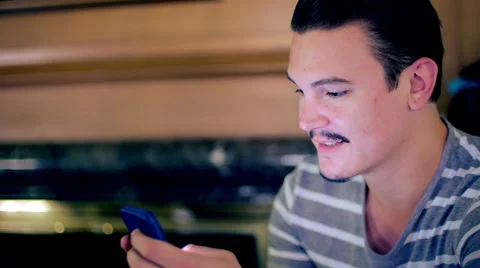 Handsome young man reading messages on cellphone 4K Stock Footage 50910573