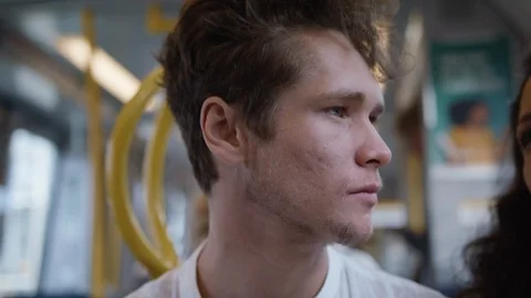 A handsome young man riding on the subway. Light flashing from the window. Video stock 116014053
