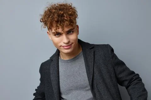 Handsome young man sexy posing coat self confidence isolated background Stock Photos