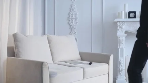 Handsome young man sitting on sofa and using laptop in room Stock Footage 73033160