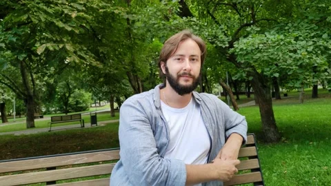 Handsome young man smiles looking at camera Stock Footage 218972140