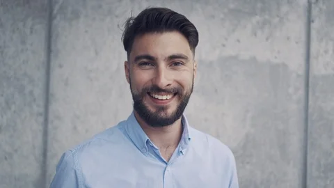 Handsome young man smiling at camera Stock Footage 112870120